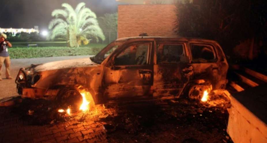 A vehicle sits smoldering in flames inside the US consulate compound in Benghazi, Libya on September 11, 2012 after an attack that killed four Americans, including Ambassador Christopher Stevens..  By STR AFPFile