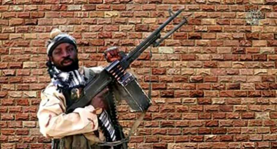 A video grab shows Boko Haram factional leader Abubakar Shekau holding a heavy machine gun.  By Handout BOKO HARAMAFPFile