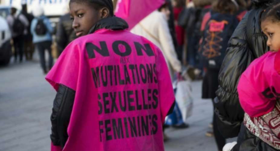A woman wears a jersey reading, No to female genital mutilation during a demonstration in 2018.  By BERTRAND LANGLOIS AFPFile