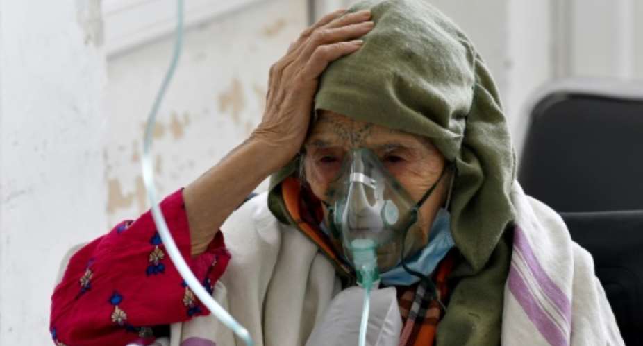A woman with Covid-19 receives oxygen at the Ibn Jazzar hospital in  Kairouan on July 4, 2021.  By FETHI BELAID AFP