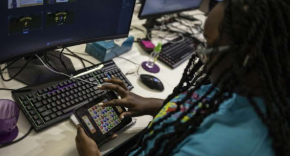 A worker plays a video game in Maliyo office in Lagos on January 20, 2025.  By OLYMPIA DE MAISMONT (AFP)