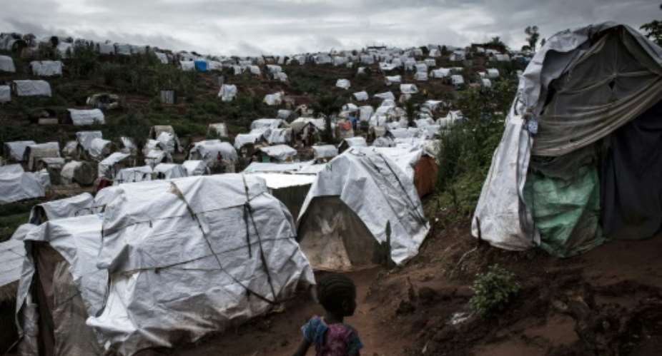 A young Congolese girl runs through a camp for Internally Displaced Persons IDP on March 20, 2018 in Kalemie, Democratic Republic of the Congo.  By John WESSELS AFPFile