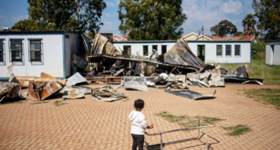 A young member of the 'Coloured' community stands in the courtyard of Oakdale Secondary School in Eldorado Park, on the outskirts of Johannesburg. Several classrooms were destroyed during a student strike in April.  By Michele Spatari AFP