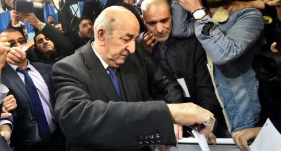 Abdelmadjid Tebboune, seen here voting in Thursday's election, has sought to distance himself from his years of service under Bouteflika.  By RYAD KRAMDI AFP