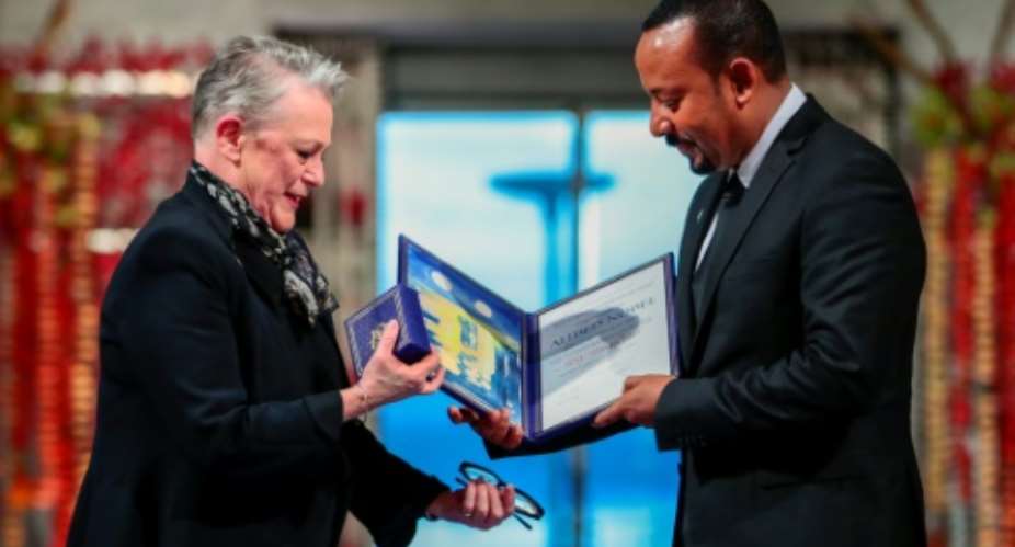 Abiy, shown here receiving the Peace Prize from the chair of the Norwegian Nobel Committee Berit Reiss-Andersen, faces rising ethnic violence at home.  By Hkon Mosvold Larsen NTB ScanpixAFP