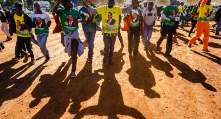 Activists from the ruling Zanu-PF march for peace in Harare ahead of polls.  By Jekesai NJIKIZANA AFPFile