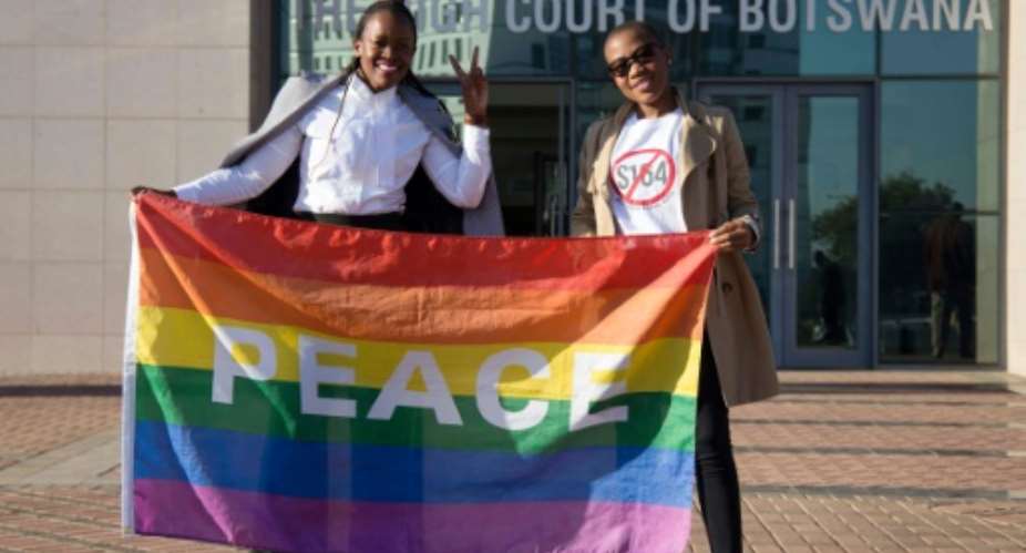 Activists pose with a rainbow flag as they celebrate the Botswana High Court's decision to decriminalize same-sex relationships.  By Tshekiso Tebalo AFPFile