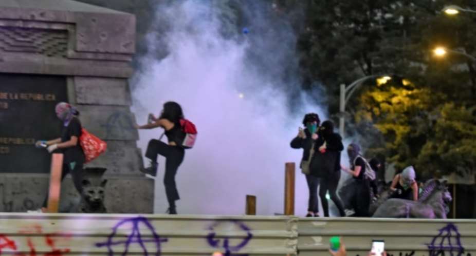 Activists vandalise a monument in Mexico City.  By PEDRO PARDO AFP