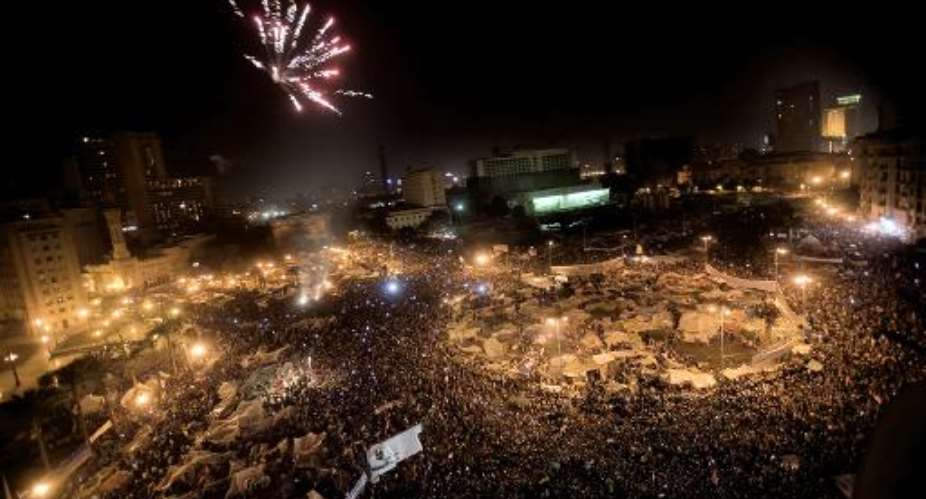 Picture dated February 11, 2011 shows Egyptian anti-government protesters celebrate under fireworks at Cairos Tahrir Square following the stepping down of president Hosni Mubarak.  By Marco Longari (AFP/File)