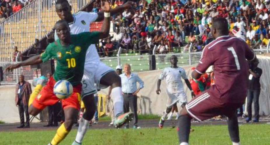 Cameroon's player Vincent Aboubacar L shoots against Mauritania goalkeeper Ibrahim Soulyemane R on June 14, 2015 at the Mamadou Ahidjo stadium in Yaounde during their 2017 African Cup of Nations qualification match.  By  AFPFile