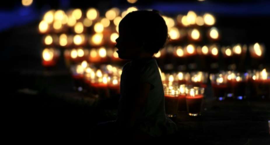 A child is seen during the solidarity world vigil for people living with HIV in San Salvador on May 17, 2015.  By Marvin Recinos AFPFile