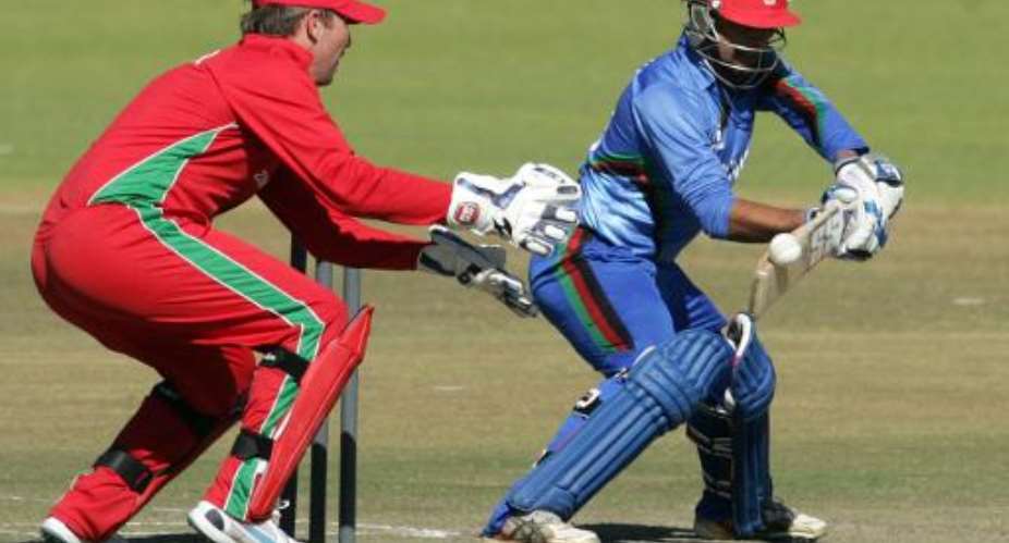 Afghanistan's batsman Noor Ali Zadran right bats next to Zimbabwe's wicketkeeper Brendan Taylor during a four match ODI series between Afghanistan and hosts Zimbabwe at the Queens Sports Club in Bulawayo on July 22, 2014.  By Jekesai Njikizana AFP