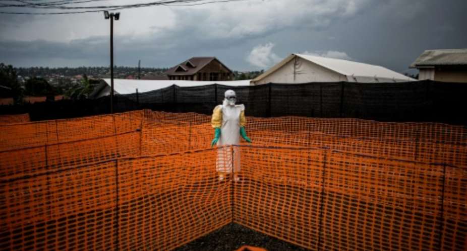 AFP photographer John Wessels received two nominations in the 2019 World Press Photo of the Year Award, including one for this photo of a Congolese health worker waiting for a suspected Ebola patient.  By John WESSELS AFPFile