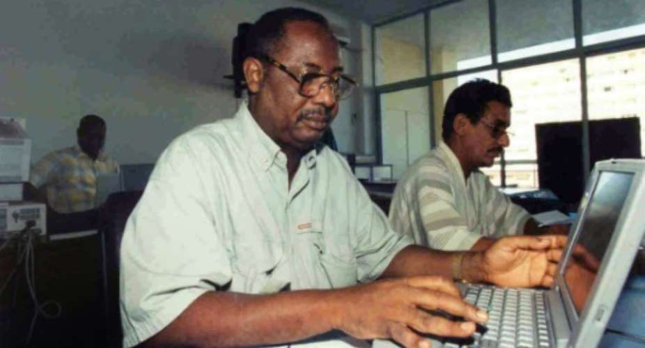 AFP's former correspondent in The Gambia, Deyda Hydara, left, pictured in the agency's Dakar bureau in 1999.  By Seyllou AFPFile