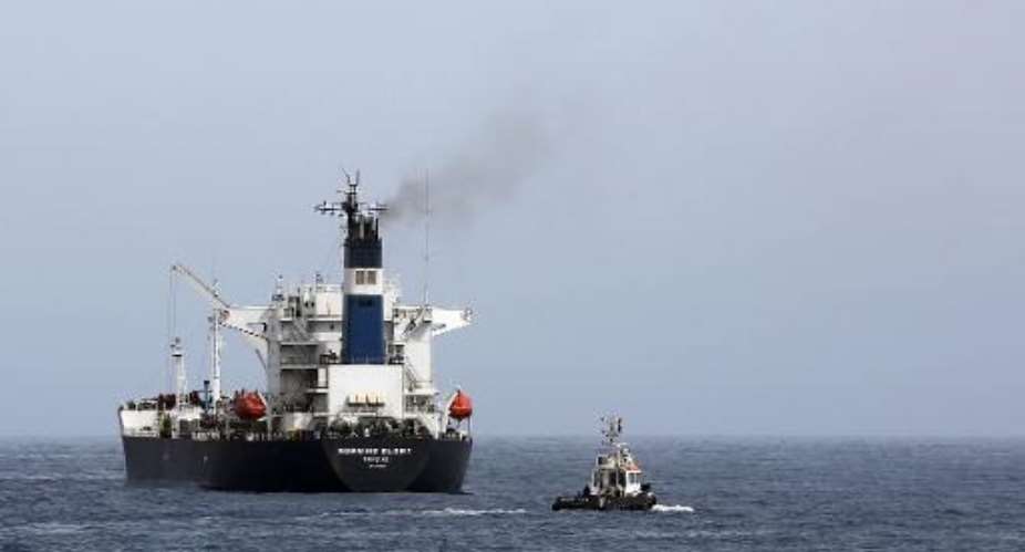 An oil tanker during the unloading of oil in the Libyan sea port of Zawiya on April 4, 2014.  By Mahmud Turkia AFPFile