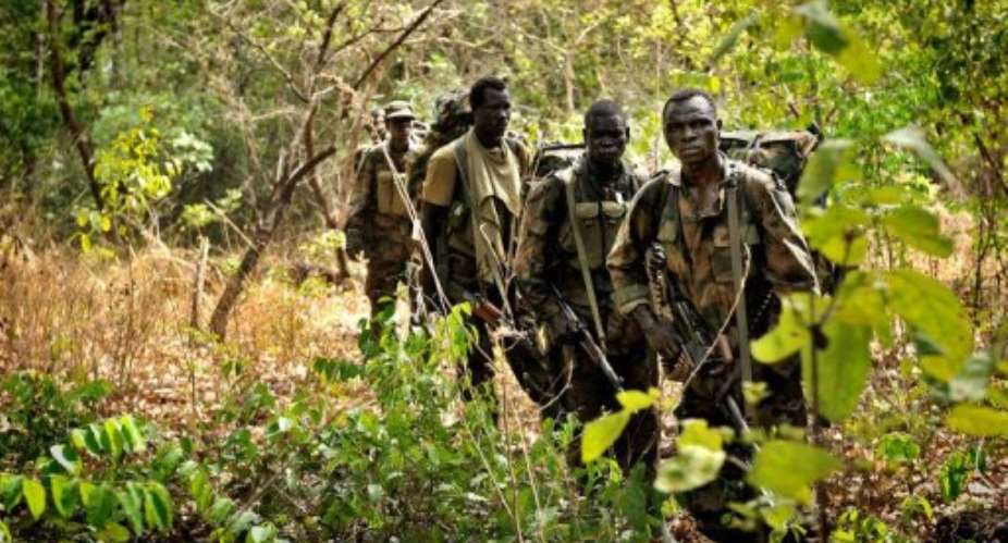 Ugandan soldiers patrol through the Central African jungle during an operation to fish out Joseph Kony.  By Yannick Tylle AFPFile