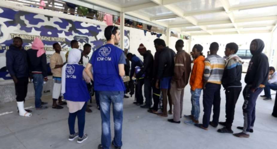 African migrants gather at a branch of the Illegal Immigration Control Agency in the Libyan capital Tripoli on April 16, 2018, to register for register for voluntary repatriation.  By MAHMUD TURKIA AFP