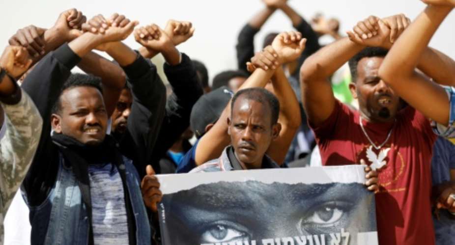 African migrants protest on February 22, 2018 outside the Saharonim Prison, where at least nine others have been incarcerated as part of Israel's policy of prison or deportation for migrants.  By MENAHEM KAHANA AFP