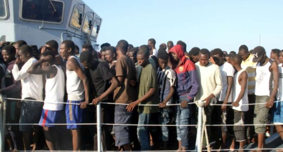 African migrants, who according to the Libyan navy were rescued by the country's coast guard, are brought to the naval base of the capital Tripoli on June 21, 2018.  By MAHMUD TURKIA AFP