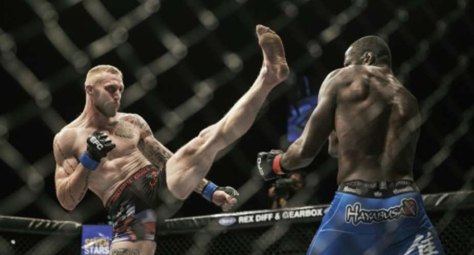 JP Kruger left and Yannick Bahati clash in a mixed martial arts middleweight contest at Carnival City in Brakpan, South Africa on May 13, 2016.  By Gianluigi Guercia AFPFile
