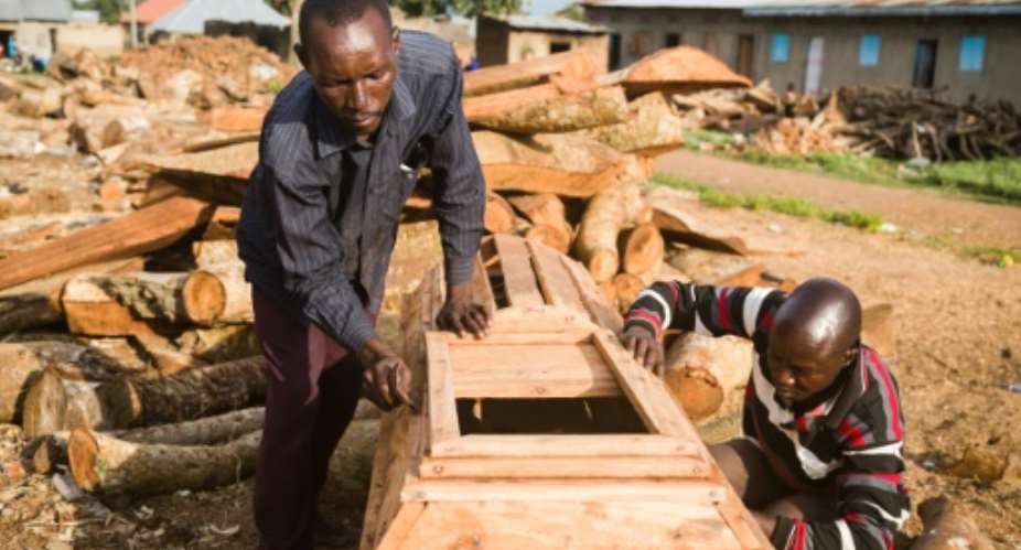 After Covid-19 school closures forced teachers out of work, many have turned to coffin-making to earn a living.  By Badru KATUMBA AFP