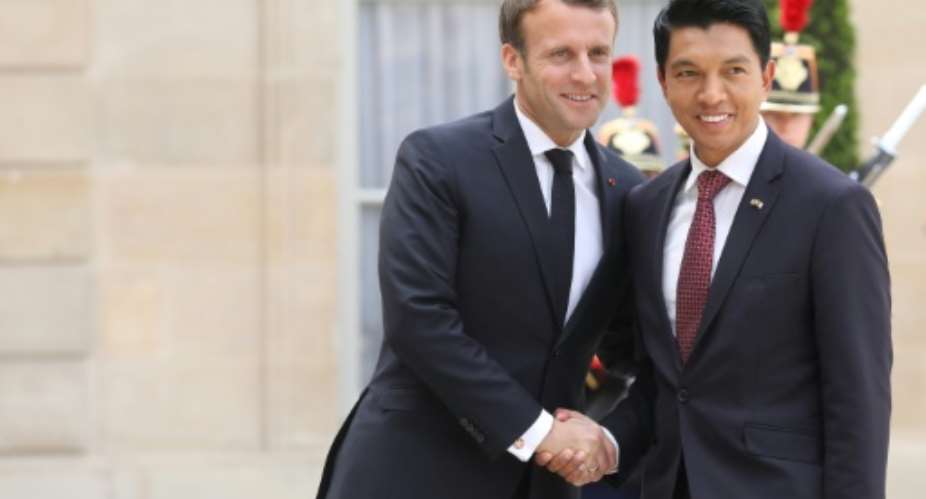 After talks with French President Emmanuel Macron L, Madagascar President Andry Rajoelina said he believed his party and allies were on course for a majority in the country's new parliament.  By Ludovic MARIN AFP