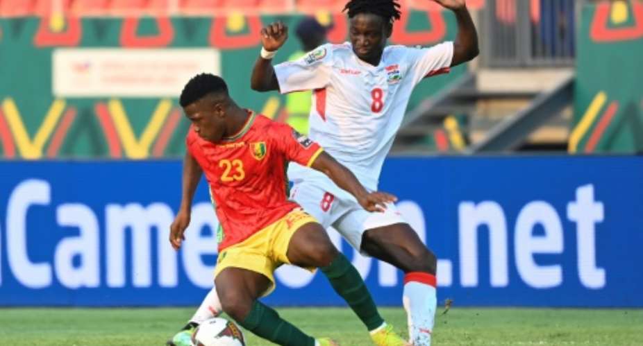 Aguibou Camara L of Guinea fights for the ball with Ebrima Darboe of Gambia in an Africa Cup of Nations last-16 match in Bafoussam on Monday.  By Pius Utomi EKPEI AFP