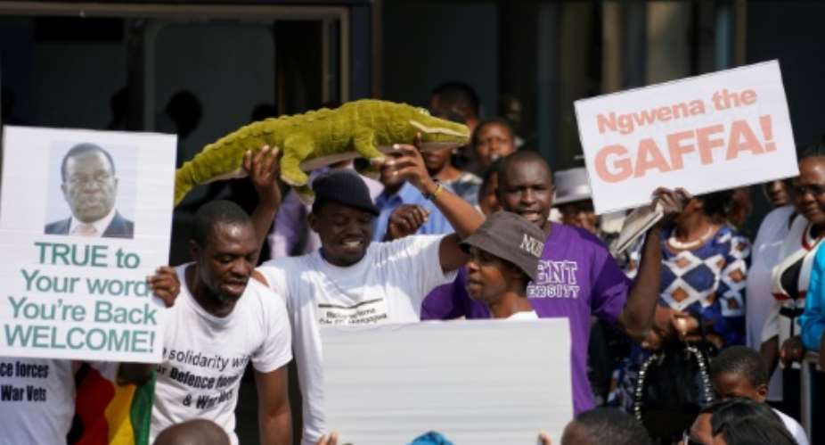 Ahead of the return of Emmerson Ngwena Mnangagwa -- a nickname meaning 'the crocodile' --  excited wellwishers gathered outside the ruling party's headquarters in Harare.  By Marco Longari AFP