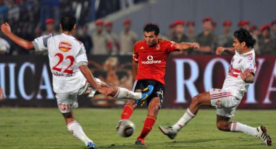 Al-Ahly's Emad Meteb centre challenges Ashur el-Adham left and Amr el-Safti of Zamalek during an Egyptian League match in Cairo on June 29, 2011.  By Mohamed Hossam AFPFile