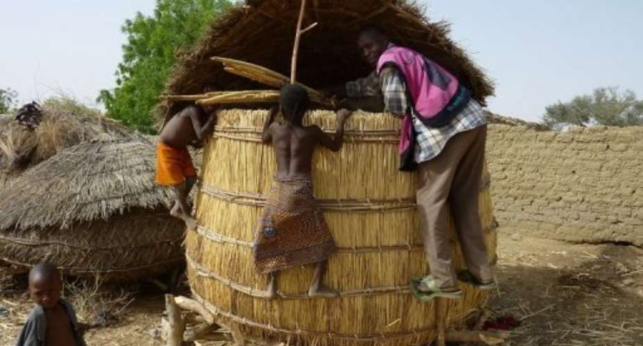 Children from the Tarna village climb on a grain silo in southern Niger in 2010.  By Boureima Hama AFPFile