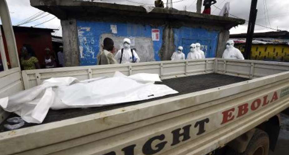 A body bag containing a person suspected of dying from the Ebola virus is collected and put on the back of a truck in Monrovia, on October 4, 2014.  By Pascal Guyot AFPFile