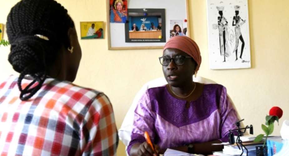 Aida Sylla, a professor of psychiatry at the Fann hospital in Dakar, talks to a patient.  By SEYLLOU AFP