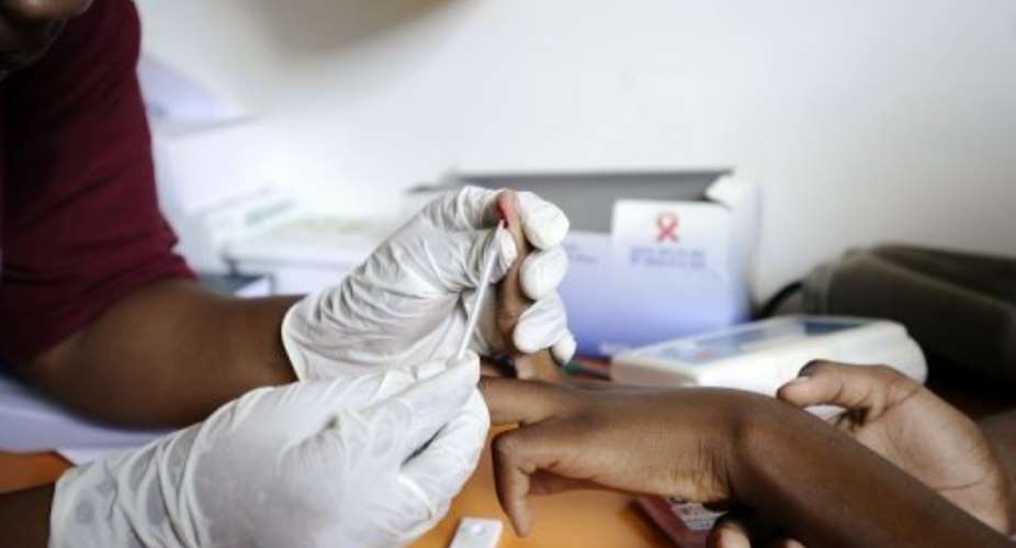 A nurse takes a blood sample in a clinic set up to test students for HIV in Kwazulu Natal on March 8, 2011.  By Stephane de Sakutin (AFP/File)