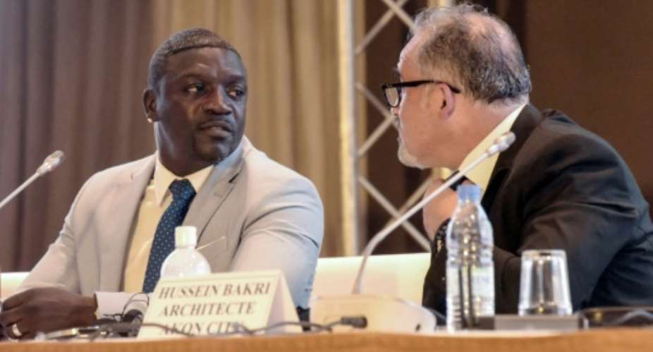 Akon said he told architect Hussein Bakri -- pictured to his left at the press conference -- I need a building that looks like a statue that you can take home... like real African sculptures that they make in the villages.  By Seyllou AFP