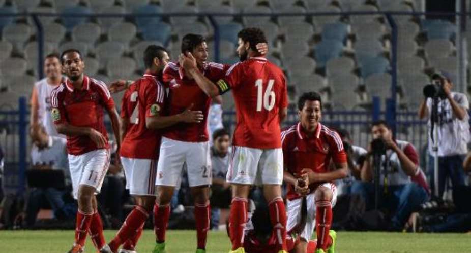 Egypt's Al-Ahly players celebrate after scoring against Cameroon's Coton Sport Club, during the second leg of their CAF Confederation Cup semi-final match, in Cairo, on September 28, 2014.  By Khaled Desouki AFPFile