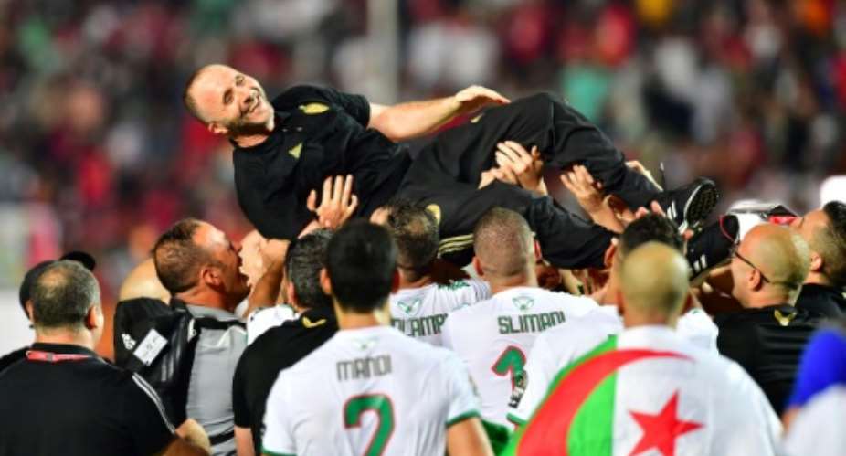 Algeria coach Djamel Belmadi is hoisted aloft by his players after leading the country to a second Africa Cup of Nations title.  By Giuseppe CACACE AFP