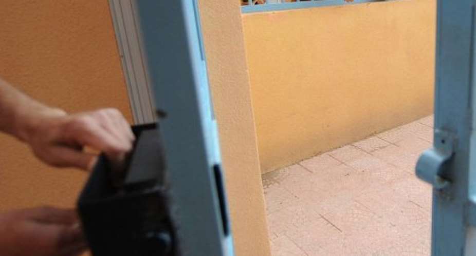 Men are seen behind bars.  By Farouk Batiche (AFP/File)