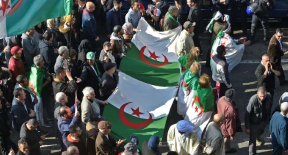 Algerian anti-government protesters have continued marching weekly for nearly a year -- despite ending the 20 year rule of President Abdelaziz Bouteflika.  By RYAD KRAMDI AFPFile