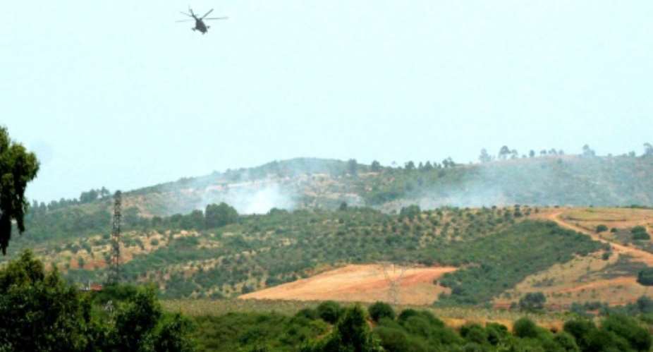 An army helicopter flies over an area where the military is fighting armed Islamists, east of Algiers.  By  AFPFile