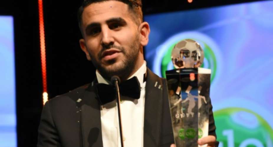 Algerian int'l and Leicester midfielder Riyad Mahrez holds the trophy after being crowned African Footballer of the Year, in Abuja, on January 5, 2017.  By Pius Utomi Ekpei AFPFile