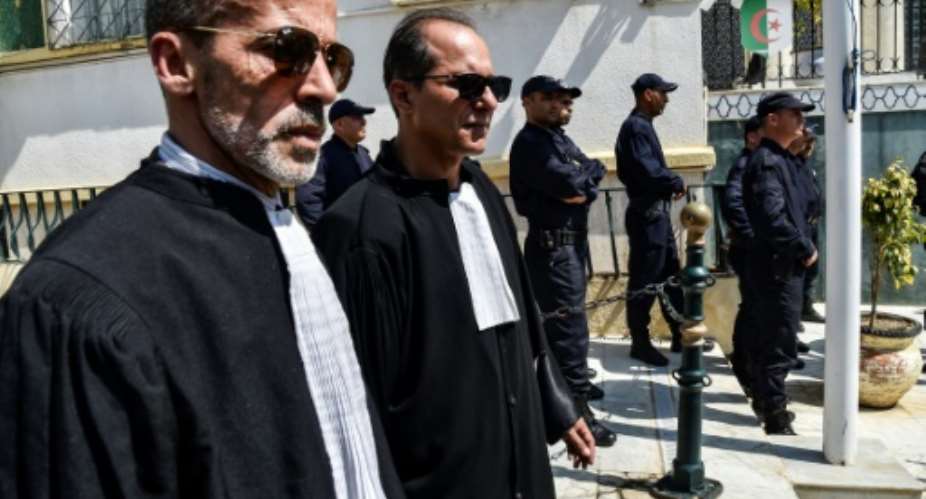 Algerian lawyers and judges gather to support the independence of the judiciary outside the Justice Ministry in Algiers on April 13, 2019. Magistrates who play a key role overseeing the country's elections, say they will boycott a July 4 presidential election.  By RYAD KRAMDI AFP