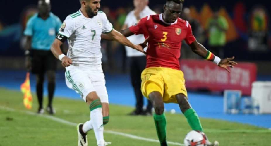 Algerian star Riyad Mahrez L tries to prevent Guinean Issiaga Sylla crossing during an Africa Cup of Nations last-16 match in Cairo.  By Khaled DESOUKI AFP