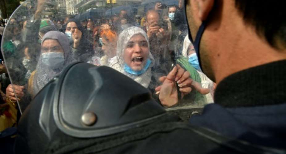 Algerian women chant slogans during a protest in the capital Algiers against a family code they say restricts their rights.  By RYAD KRAMDI AFP