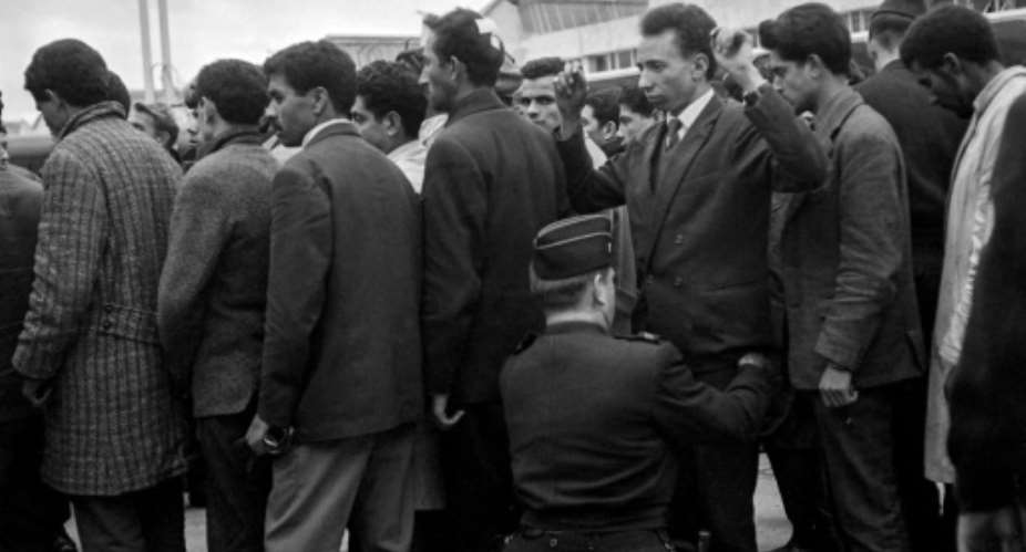 Algerians arrested during the demonstration in Paris on October 17, 1961  are searched before boarding a plane bound for Algeria.  By - AFP