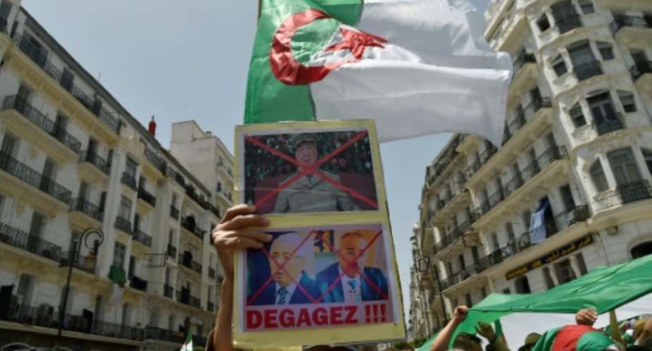 Algerians demonstrate for a 16th consecutive Friday demanding a political overhaul in the North African country after the ouster in April of veteran president Abdelaziz Bouteflika before new presidential polls can be held.  By RYAD KRAMDI AFP