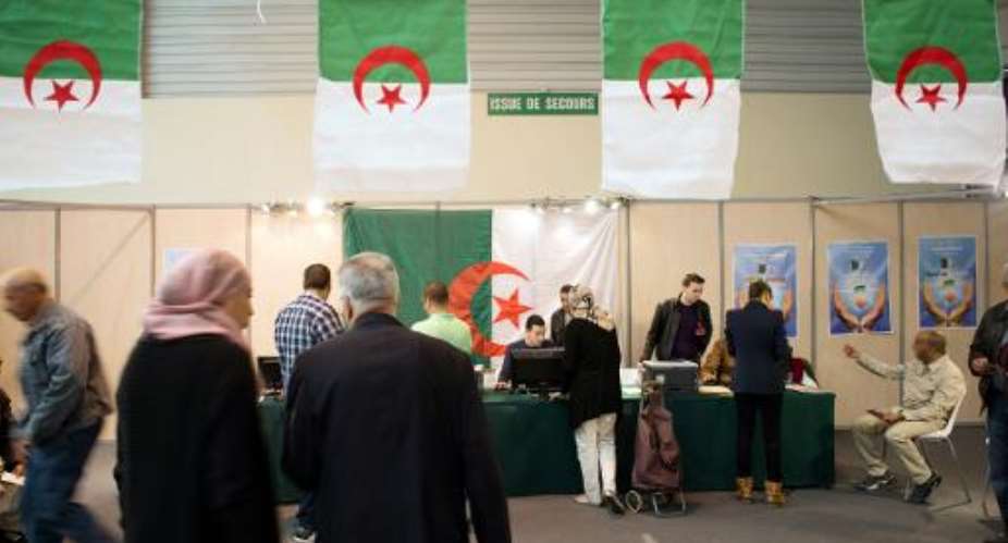 Algerian people prepare to vote at a polling station in the Chanot Park on April 12, 2014 in Marseille, southern France.  By Bertrand Langlois AFP