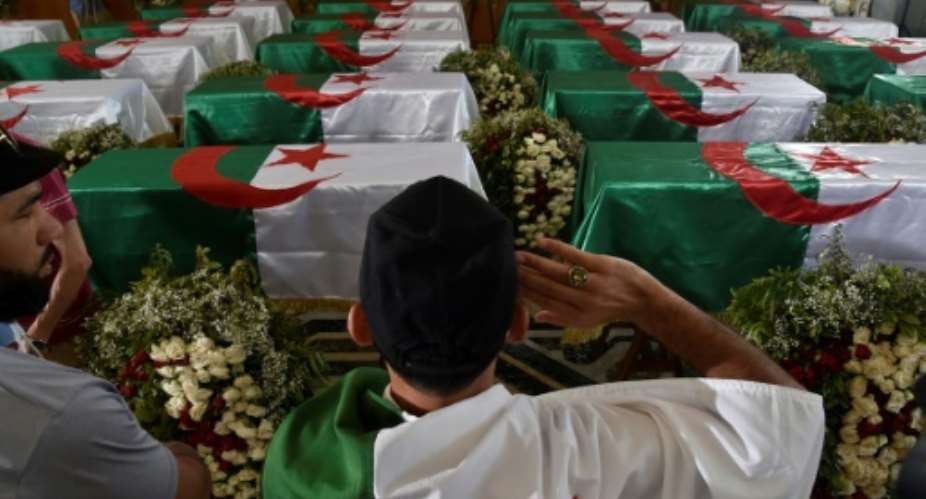 Algerians paid their respects before the 24 coffins of anti-colonial resistance fighters repatriated to Algiers by France before their burial.  By RYAD KRAMDI AFP