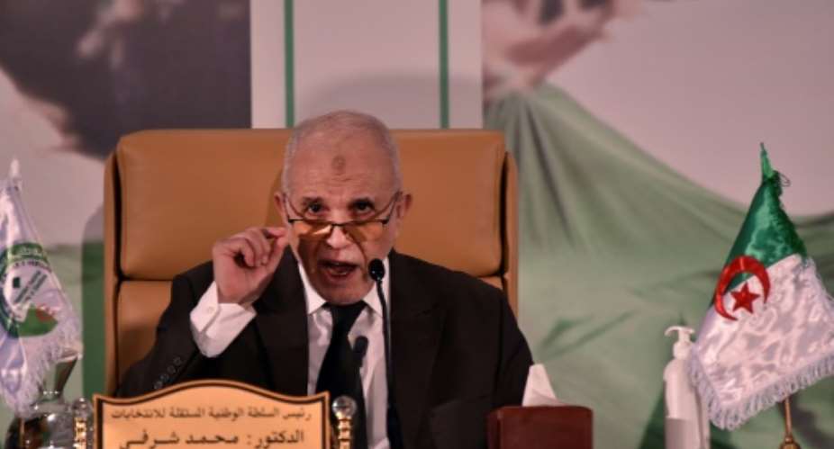 Algeria's electoral authority chief Mohamed Charfi announcing the result of the referendum on Monday.  By RYAD KRAMDI AFP