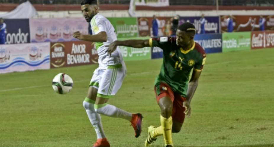 Algeria's Riyad Mahrez L fights for the ball with Cameroon's Aurelien Chedjou during their FIFA World Cup 2018 qualifying match at Stade Tchakert in Blida, on October 9, 2016.  By RYAD KRAMDI AFPFile