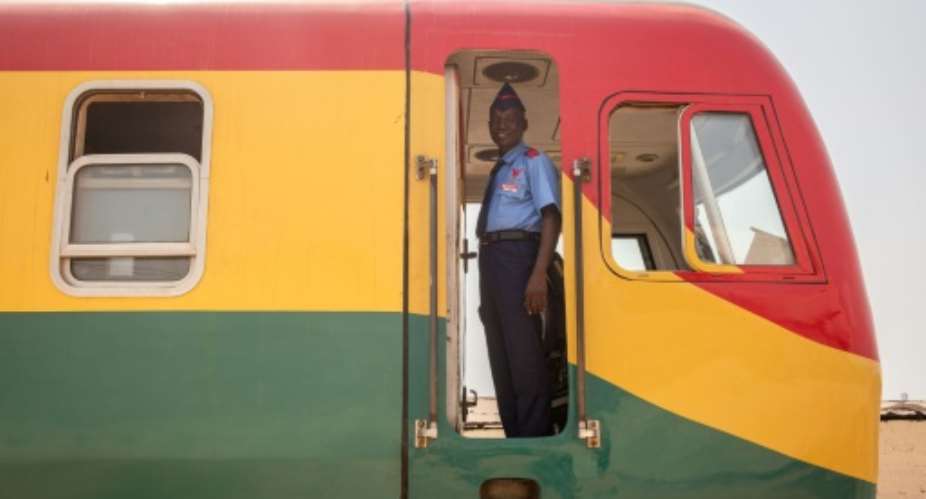 All on board: The trains proudly sport Ghanas national colours.  By RUTH MCDOWALL (AFP)